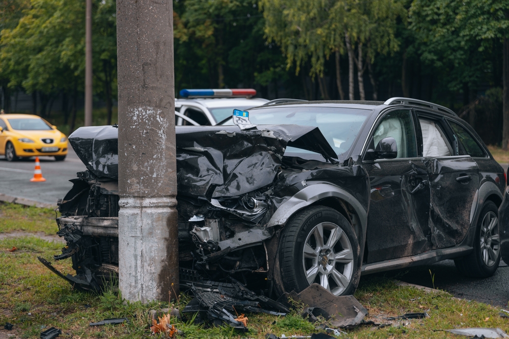 Crashed car with severe front-end damage after a collision in Bronx.