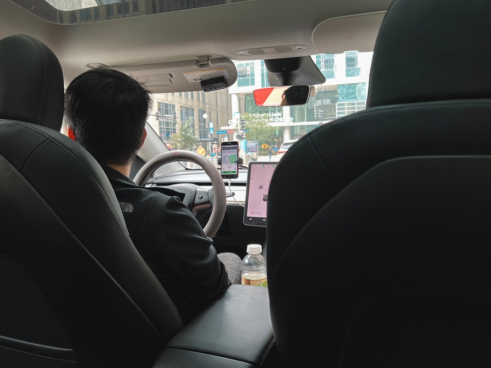 Passenger’s view of a rideshare driver navigating through city streets
